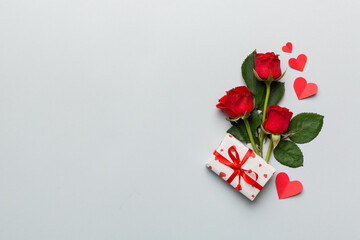 Valentine's day composition with rose flower, red heart and gift boxes on table. mother day and birthday greeting, copy space, top view