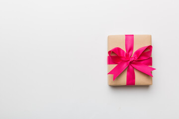 Holiday present box over colored background, top view. Copy space for design