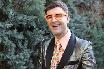 Funky man wearing sequins blazer and floral tie