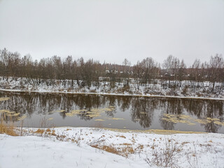 Cloudy day in winter on the river bank