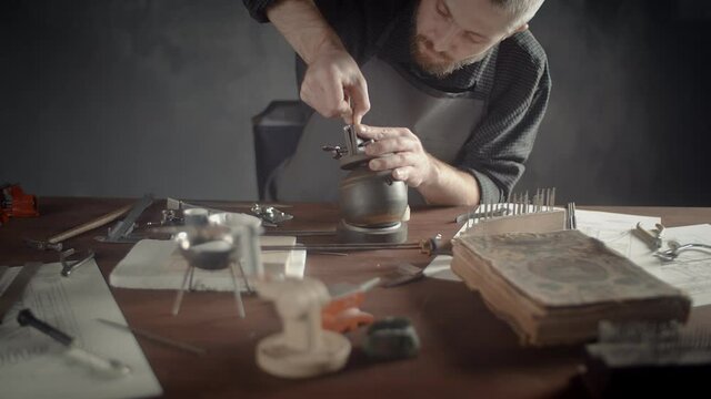 A male jeweler making jewelry. Creating beautiful accessories