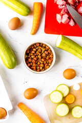 organic pets food with eggs, zucchini and carrot white background top view