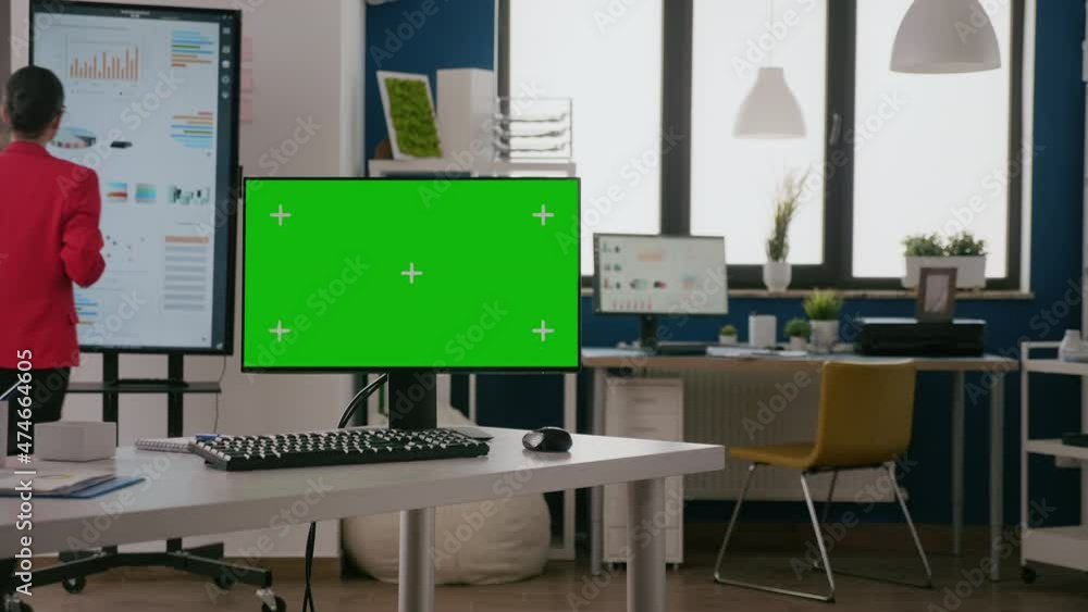 Poster computer with green screen on display at empty office. monitor with isolated template and mock up ba