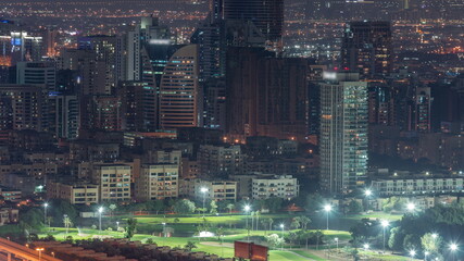 Obraz premium Aerial view of greens and al barsha heights district area night timelapse from Dubai marina.