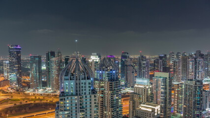 Fototapeta na wymiar Dubai marina and JLT skyscrapers along Sheikh Zayed Road aerial night timelapse.