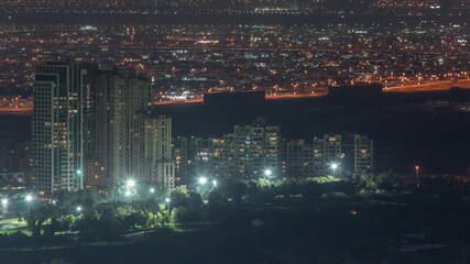 Aerial view of greens district area night timelapse from Dubai marina.