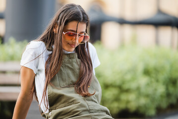Young woman on a park bench posing at the camera