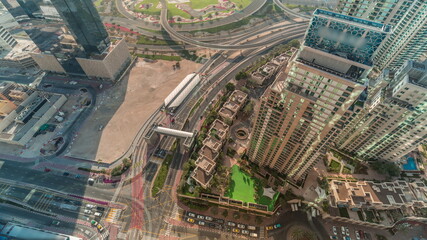 Aerial view of a road intersection between skyscrapers between skyscrapers all day timelapse.