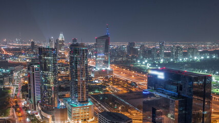 Naklejka na ściany i meble Aerial view of media city and al barsha heights district area all night timelapse from Dubai marina.