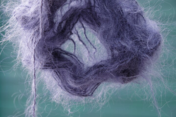 Purple mohair on a dark turquoise background. The color of 2022. 