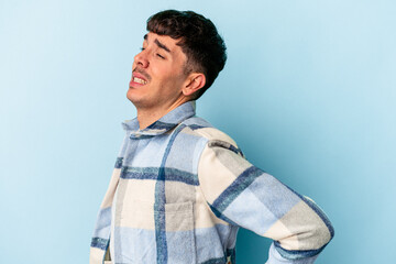 Fototapeta premium Young mixed race man isolated on blue background suffering a back pain.