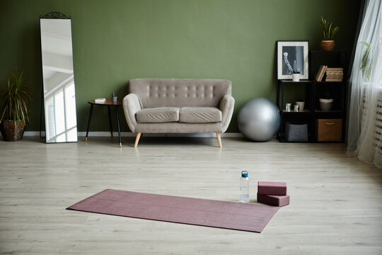 Background image of home interior with yoga mat on floor, indoor workout concept, copy space