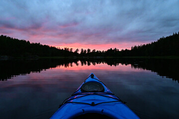 First person view from Kayak on a natural Norwegian lake in a magical sunset evening