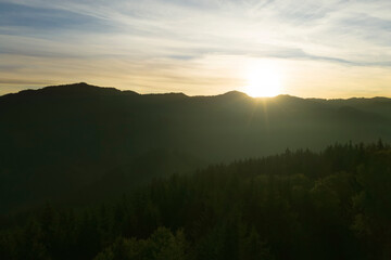 Fototapeta na wymiar Aerial view of beautiful mountain landscape with green trees at sunrise