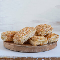 Potato Burekas on wooden background. Israeli Savory Potato Pastries.