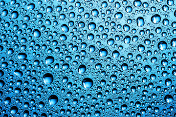 Water drops background. Wet glass surface texture. Bubble dew pattern. Transparent window blue raindrops. Perfectly round droplet design backdrop. Bright blue environment condensation texture.