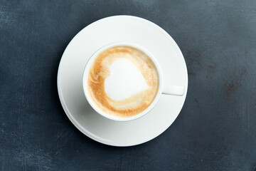 Cup of cappuccino. Drawing in the form of a heart.