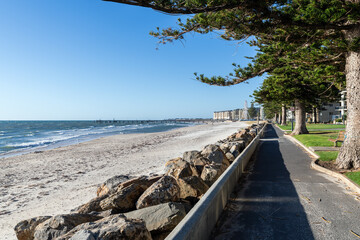 Iconic Glenelg Beach Esplanade on a bright summer day. The jetty can be seen in the background, South Australia