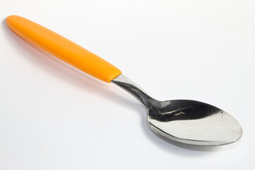 Metal spoon with yellow handle