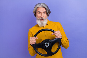 Photo of senior man impressed drive automobile vehicle traffic nervous isolated over purple color background