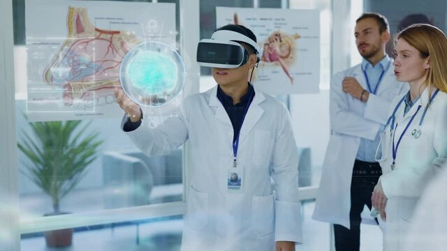 Future Medicine. Doctors discussing Human Brain Surgery wearing Virtual Reality Glasses. High Tech Technologically. Brain Scan Tomography. Technologically Hospital. Artificial Intelligence