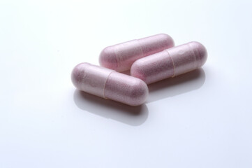 close up of medical capsules on white background