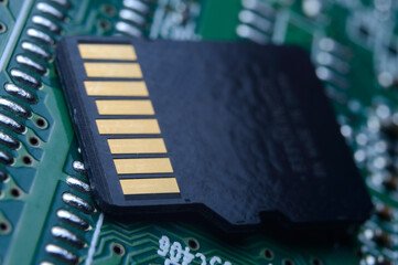 the black micro sd card lies on the microcircuit. close-up.