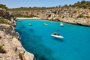 Fototapeta na wymiar Turquoise waters in Mallorca. Pilota cove. Mediterranean coastline. Balearic islands
