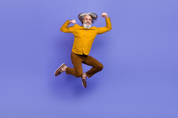 Obraz premium Full length body size view of attractive cheery strong gray-haired man jumping striving isolated over bright violet purple color background