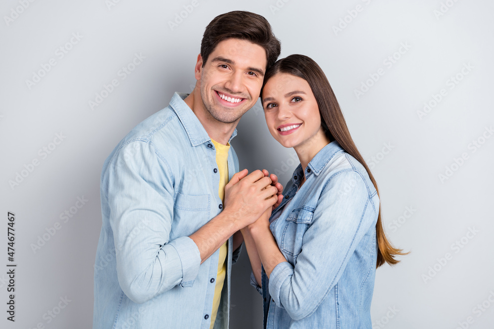 Poster Photo of adorable dreamy young lady guy wear jeans shirts holding arms smiling isolated grey color background