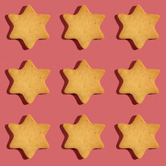 Seamless pattern with Hanukkah cookie on dark pink background.