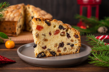 Traditional Christmas Dundee cake with dried fruits and almonds on a wooden board. Festive dessert. Rustic style, selective focus