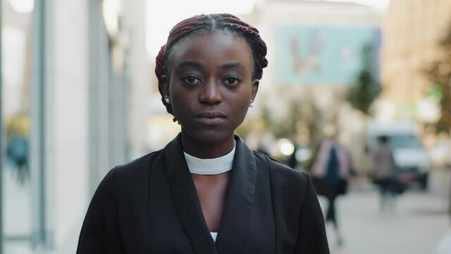 Female portrait outside confident powerful sad upset serious african american business woman girl young lady model looking at camera standing in city on street outdoors alone loneliness racism concept
