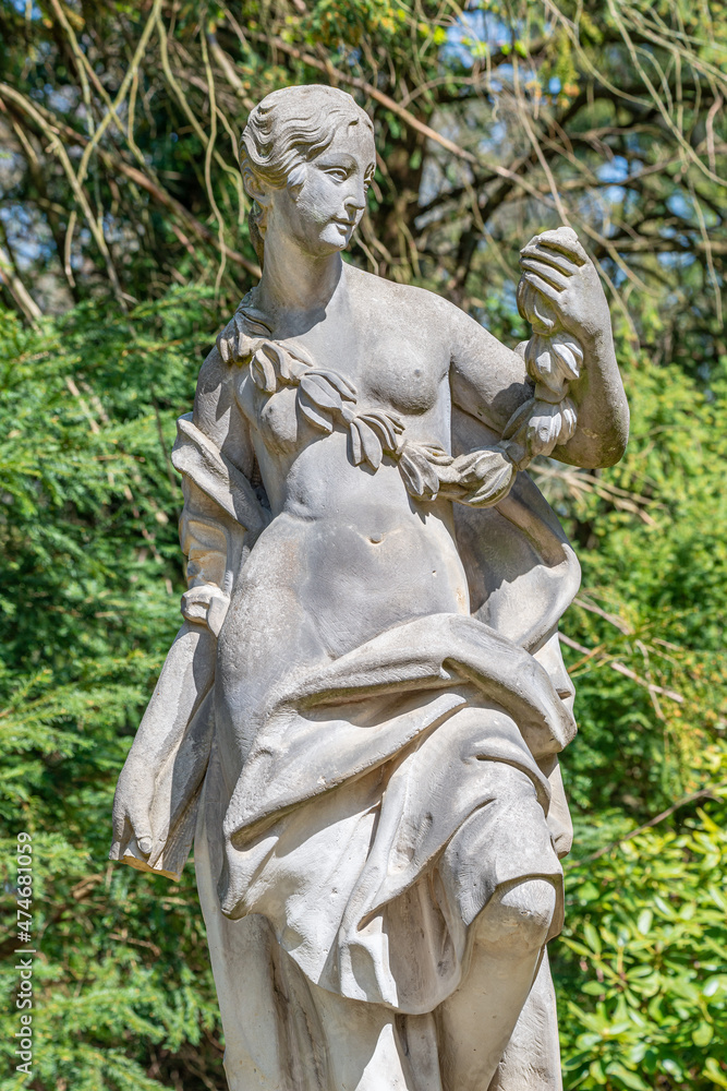 Poster ancient decayed statue of a sensual renaissance era woman in the central city park of potsdam, a ger