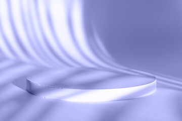 Podium for the presentation of cosmetic products. Large round advertising stand with shade of a palm tree in Very Peri color of the year. Podium layout for cosmetic product presentation