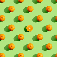 Seamless pattern with mandarin orange on green background.