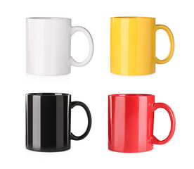 Set with different ceramic mugs on white background