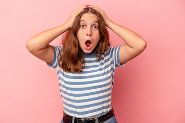 Fototapeta premium Little caucasian girl isolated on pink background surprised and shocked.
