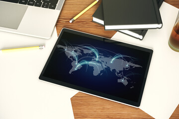 Top view of modern digital tablet monitor with abstract world map with connections, research and strategy concept. 3D Rendering