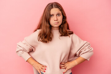 Obraz premium Little caucasian girl isolated on pink background sad, serious face, feeling miserable and displeased.