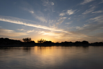 Obraz premium Stunning sunset over the shallow waters of the Elafonisi lagoon (deer island) on the southwest tip of Crete, Chania region, Greece.