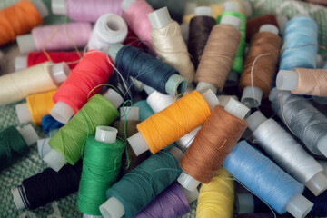 Sewing threads as a multicolored background. High angle view of colored threads for tailor job
