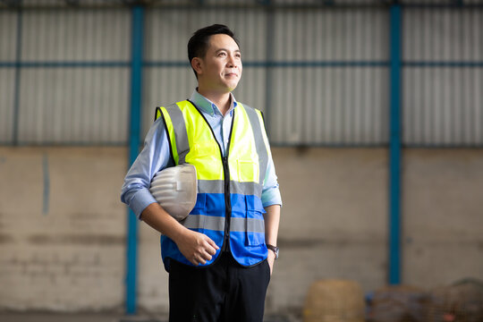 Portrait of asian man worker in warehouse. logistic and business import export.