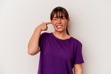 Young Argentinian woman isolated on white background covering ears with hands.