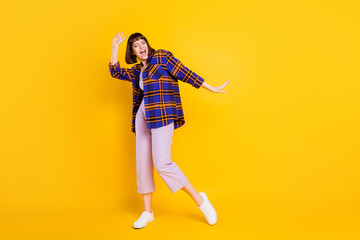 Fototapeta na wymiar Full length body size view of attractive cheerful girl having fun moving dancing isolated over bright yellow color background