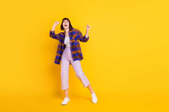 Full length body size view of pretty cheerful girl dancing having fun rest relax chill isolated over bright yellow color background