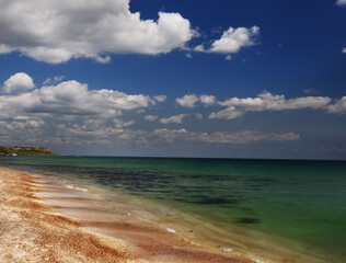 Wonderful sea landscape. Sandy beach and green promontory in the distance. Odessa. Ukraine.