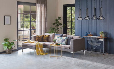 Modern grey sofa in front of the garden view and wooden background wall, lamp vase of plant and middle table, home design.