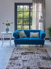 Blue classic sofa in front of the window, carpet design, white table vase of plant, lamp, garden background.