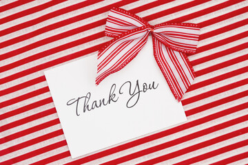 Fototapeta premium Thank you greeting card with red and white candy cane bows